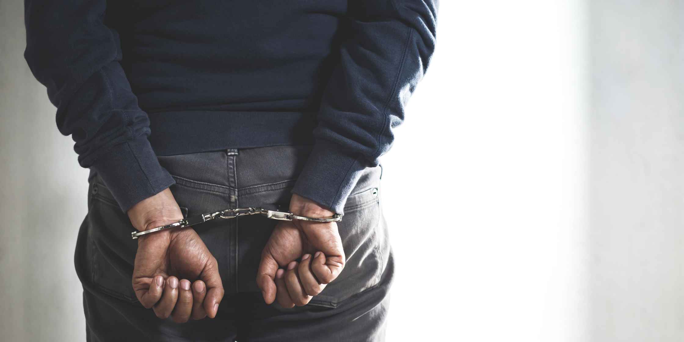 Handcuffed individual representing a first DUI arrest in Colorado Springs.