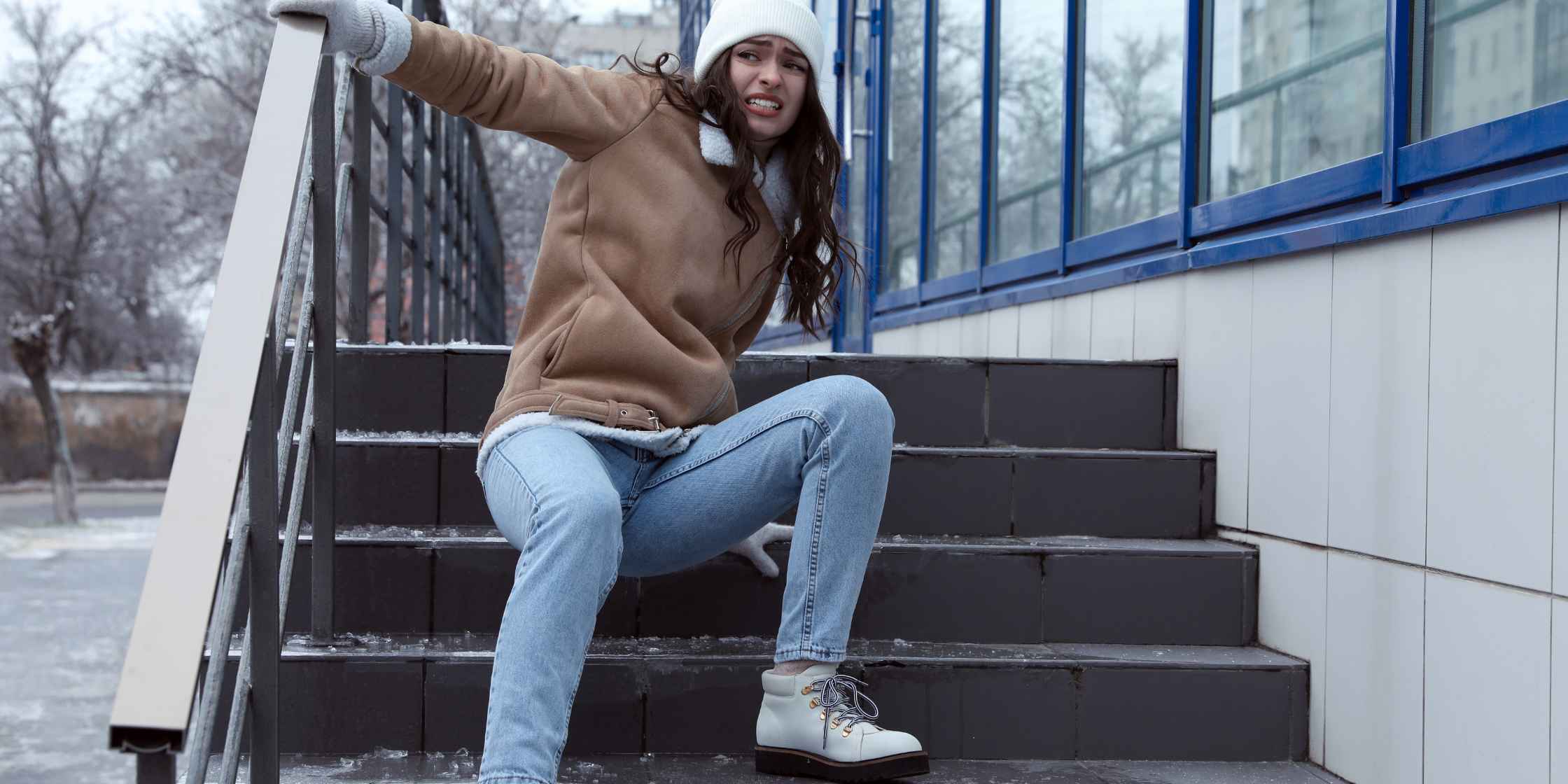 Person slipping on icy stairs, capturing a moment of a potential personal injury accident.